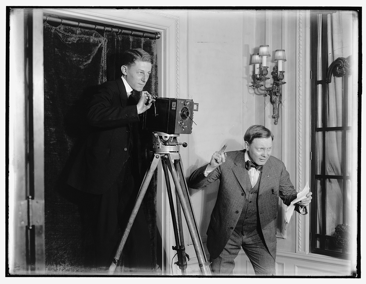Photo of two men with a movie camera